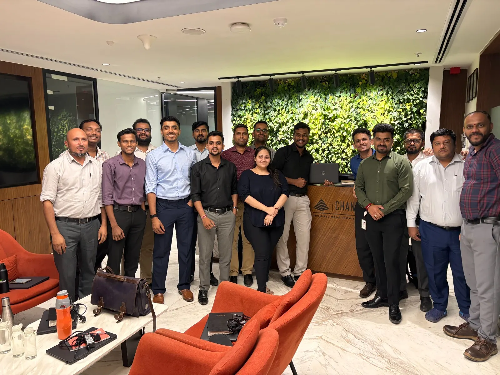 Group photo of trainers and client team in an office lobby